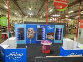 Custom Island Exhibit with Freezers, Sitting Area, Reception Counters, Locking Storage, and Large Format Graphics
