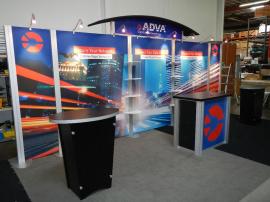 RENTAL:  RE-2009 Arch Canopy, Halogen Arm Lights, RE-1202 Counter, (2) RE-1201 Counters, and Clear Acrylic Shelves. Tension Fabric Graphics, and Sintra Header and Counter Graphics -- Image 2