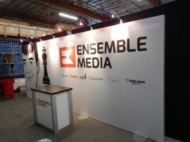 RENTAL: Inline Exhibit with SEG Fabric Graphic, Halogen Arm Lights, and RE-1202 Counter -- Image 1