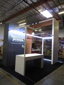 Custom Island Exhibit with Powder-coated SuperNova Lightboxes, Laminated Tower and Closet, Puck, Pendant, and Track Lighting, Shelves, and Genius Bar
