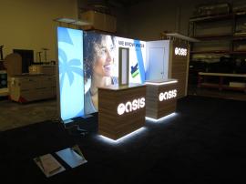 Custom Inline Lightbox Exhibit with Backlit Dimensional Logos, Custom Counters. Monitor Mounts, and Closet and Counter Storage. Reconfigures to 10 ft.