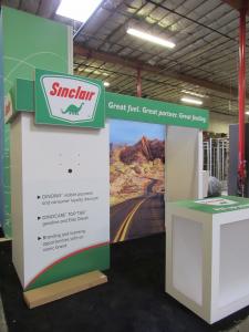 Custom Inline Exhibit with Lightboxes, Wraparound Headers, Monitor Mount, and Custom Wood Counter with Branding